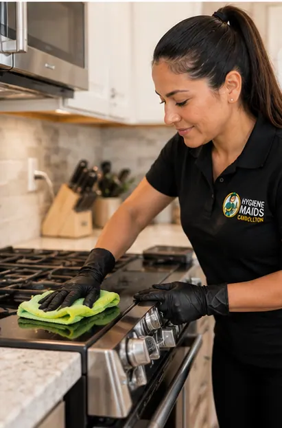 A cleaner wiping the top of a stainless range